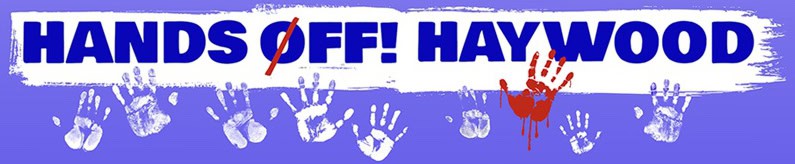 Community protest banner with handprints and 'Hands Off! Haywood' text.